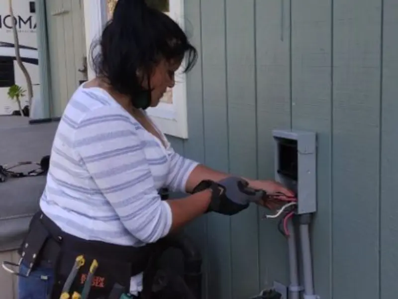 Licensed electrician wiring an exterior subpanel in Hurlburt Field